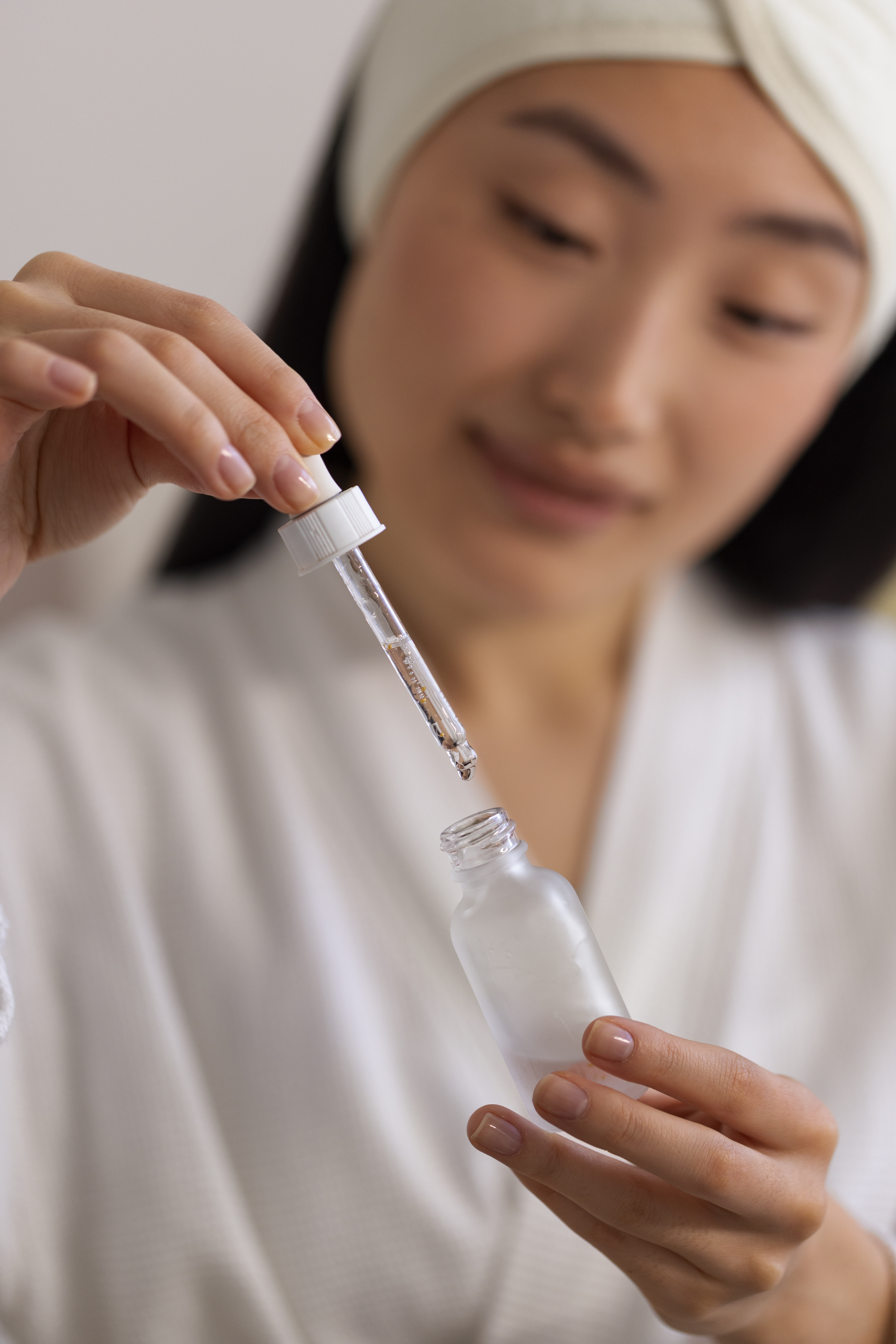 asian woman using chemical peel serum